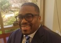 A man in glasses smiling at the camera