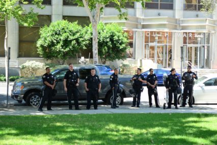 Police officers standing in a row on the sidewalk in San Jose, California