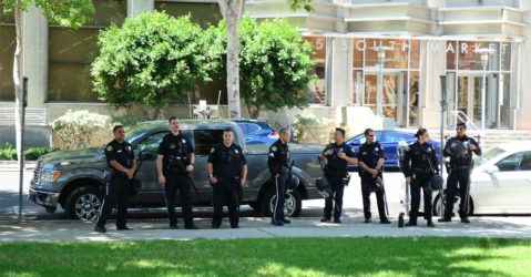 Police officers standing in a row on the sidewalk in San Jose, California