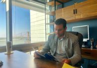 Man sitting at desk reading documents.
