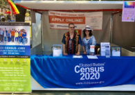 People standing behind a booth