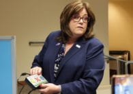 Woman holding new audio voting machine