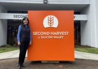 Woman standing next to orange sign