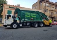 A Waste Management truck collects garbage in Oakland, Calif.