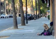 A homeless man sits on the corner of Third and Santa Clara streets in downtown San Jose. Photo by Ramona Giwargis.