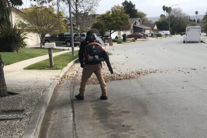 A person using a leaf blower on a street in San Jose, California