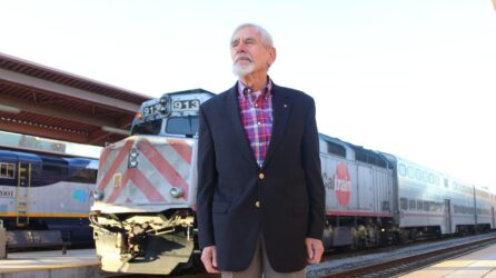 Rod Diridon A man stands in front of a train at a station in San Jose, California
