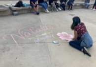 A youth attending the April 24 celebration of life for transgender woman Natalia Smut in San Jose draws a message for her in chalk. Photo by Vicente Vera.