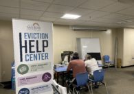 two people sit at a table with their backs turned to the camera