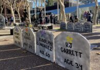 A row of makeshift tombstones at a memorial for homeless people who died on the streets