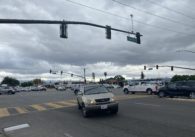 A car turns at an intersection in San Jose