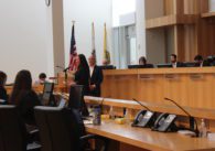 People speaking in a government meeting