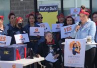 Woman standing and sitting outside with political signs