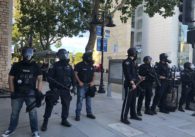 A line of police officers in riot gear