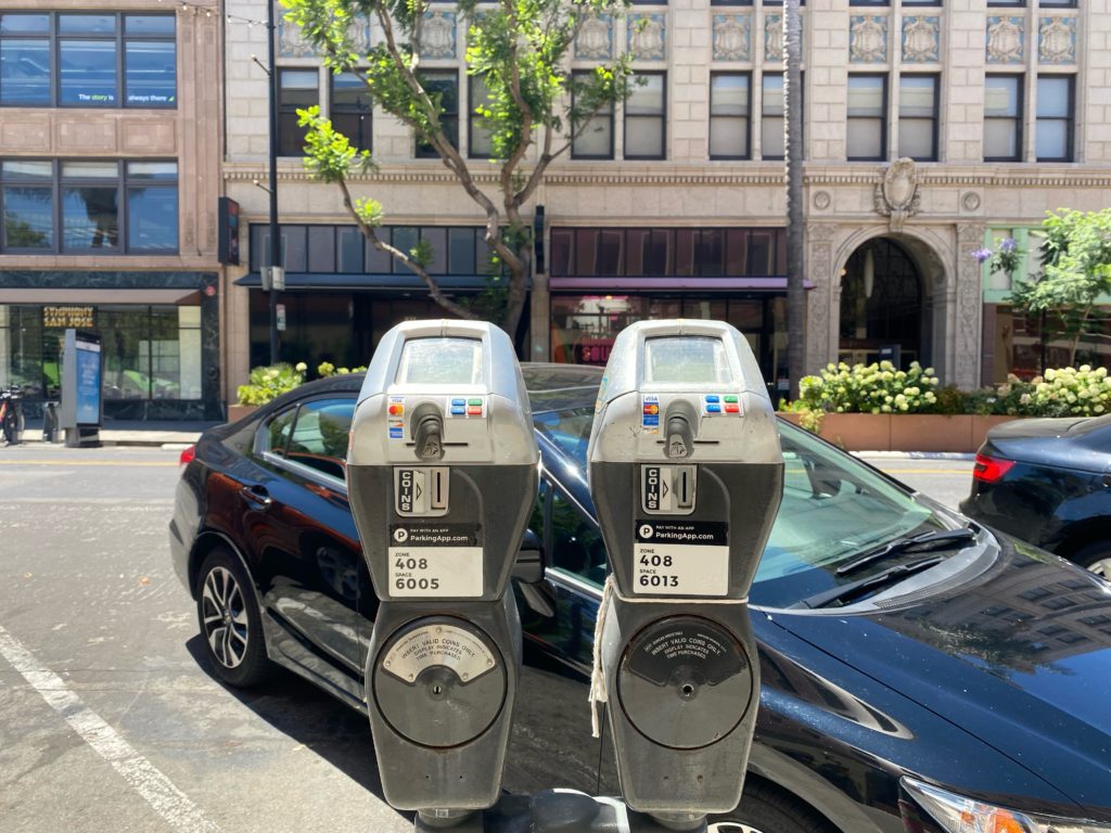 Parking meters in front of a car in San Jose, California