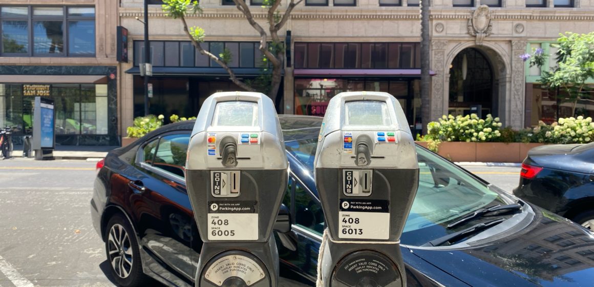 Parking meters in front of a car in San Jose, California