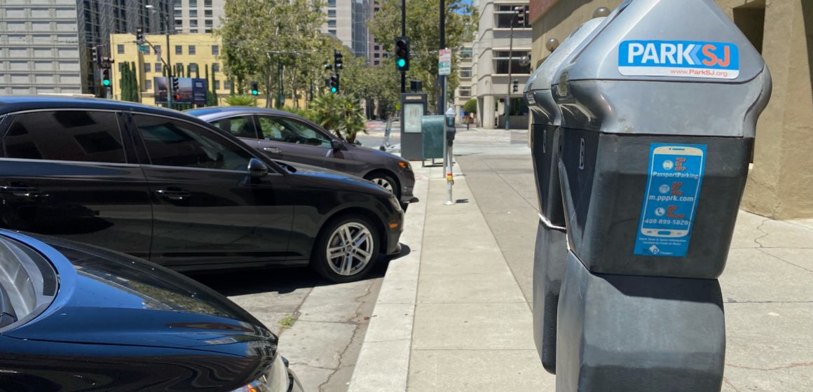 Parking meters next to a row of cars in San Jose, California