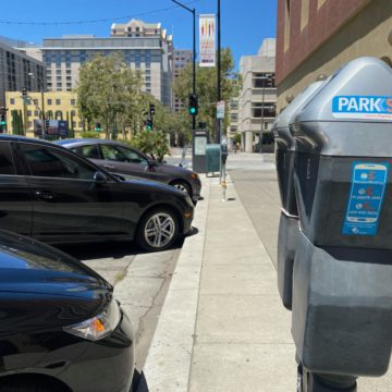 Parking meters Parking meters next to a row of cars in San Jose, California