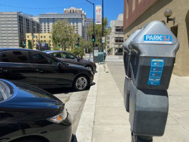 Parking meters Parking meters next to a row of cars in San Jose, California