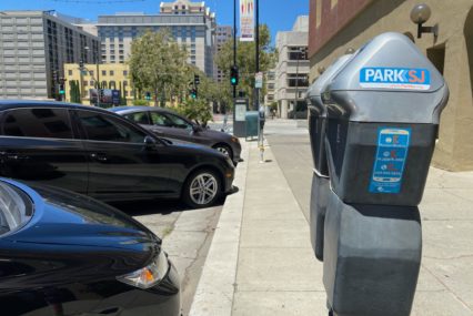 Parking meters next to a row of cars in San Jose, California