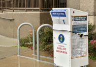 A vote-by-mail ballot drop box outside on the sidewalk