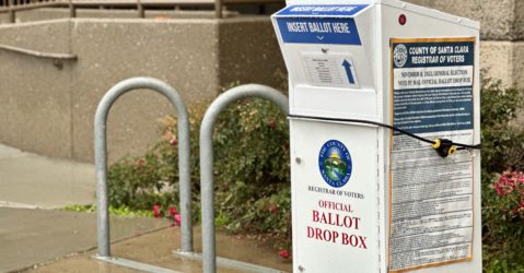 A vote-by-mail ballot drop box outside on the sidewalk