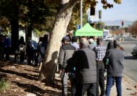 A line of people waiting for food donations