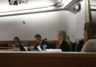 A group of people sitting in chairs at a dais