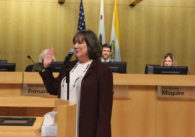 A woman stands in front of a podium