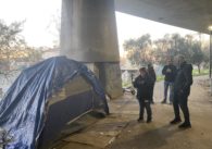 A group of people standing outside a tent