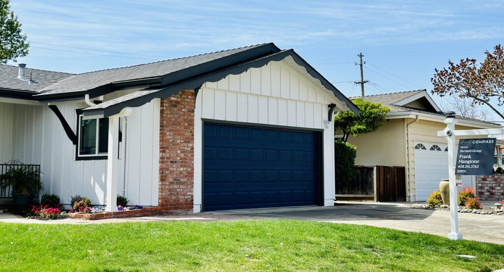 A single-family home with a for sale sign next to the lawn