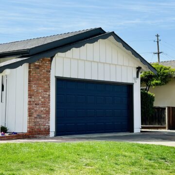 A single-family home with a for sale sign next to the lawn