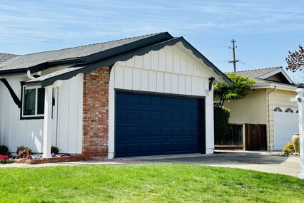 A single-family home with a for sale sign next to the lawn