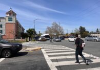 A man walking across the street in a crosswalk