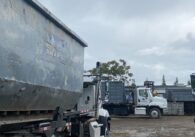 Recycling trucks parked in a yard