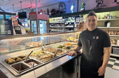 A man standing in front of a hot food bar in San Jose, California