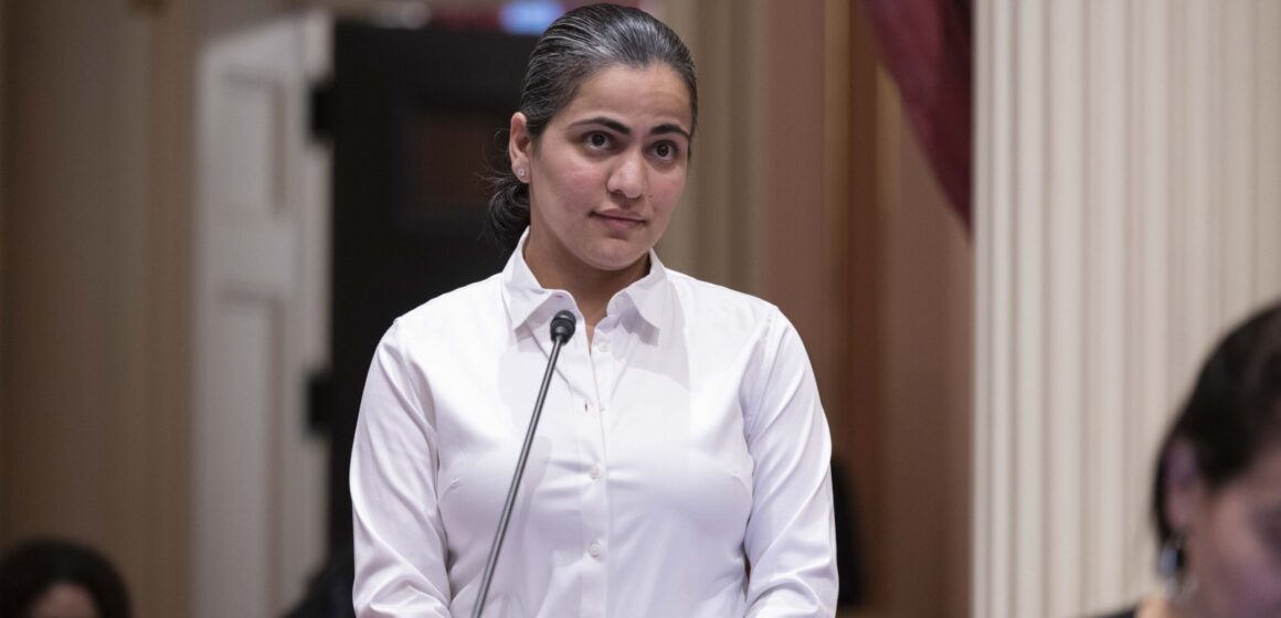 A woman stands on the floor of the California Senate