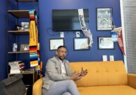 A man sitting on a couch inside an office