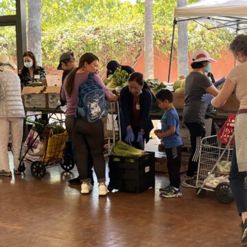 People waiting in line at a food distribution event