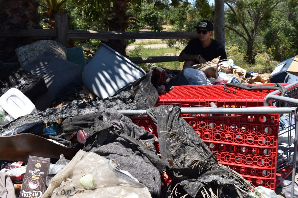 An abandoned shopping cart full of trash