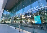 The exterior glass doors to a library in downtown San Jose