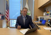 Sunnyvale Mayor Larry Klein signs a certificate in his office.