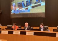 Milpitas interim city manager Ned Thomas speaking and sitting behind the city council dias. City attorney Michael Mutalipassi and Vice Mayor Evelyn Chua sit beside him.