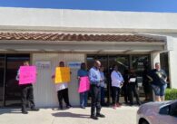 Group of advocates, NAACP representatives, and former HomeFirst employees rallying in front of the HomeFirst offices