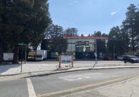 Office building that currently occupies 1202 Kifer Road from the front, bordered by trees, with the exit from Lawrence Expressway in front of it.