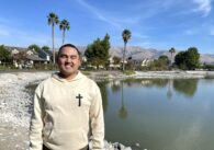 Former Milpitas Mayor Rich Tran standing in front of a small lake with the Milpitas Hills in the background