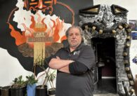 Dan Vado and the massive Tiki head at the bathroom entrance. Photo by Robert Eliason.