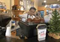 Bean Scene Café owner Kenny Lam pulls espresso shots and steams milk for a customer's latte.