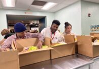 People packing boxes full of food