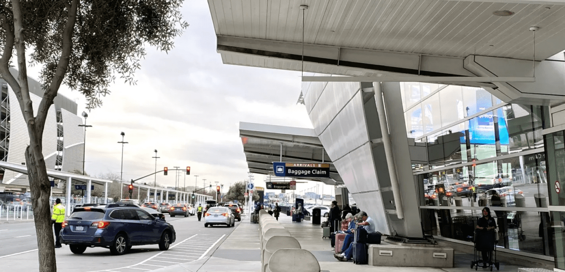 Cars pulling in at the loading and unloading curb by San Jose airport